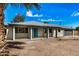 Delightful single story home featuring an attached garage and an appealing xeriscaped front yard with a vibrant blue door at 5902 W Wolf St, Phoenix, AZ 85033