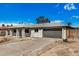 Attractive single story home featuring well maintained landscaping, attached garage and eye-catching blue front door at 5902 W Wolf St, Phoenix, AZ 85033