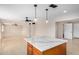 Bright kitchen with white marbled island, tile flooring, and a modern open layout into the living area at 5902 W Wolf St, Phoenix, AZ 85033