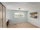 Bedroom featuring a ceiling fan, light walls, new flooring, and lots of natural light at 6830 W Mckinley St, Phoenix, AZ 85043