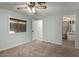 This is a bright bedroom with light walls, gray carpet, and an attached bathroom at 6830 W Mckinley St, Phoenix, AZ 85043