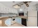 Bright kitchen featuring a ceiling fan, light cabinetry, and modern flooring at 6830 W Mckinley St, Phoenix, AZ 85043