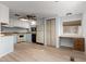 Bright kitchen featuring a ceiling fan, light cabinetry, and modern flooring at 6830 W Mckinley St, Phoenix, AZ 85043