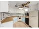 Bright kitchen featuring a ceiling fan, light cabinetry, and modern flooring at 6830 W Mckinley St, Phoenix, AZ 85043