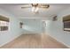 Bright living room showcasing a ceiling fan, light walls, new flooring, and ample natural light at 6830 W Mckinley St, Phoenix, AZ 85043