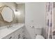 Stylish bathroom featuring modern vanity with an octagonal mirror and a shower with a curtain at 718 W Vine Ave, Mesa, AZ 85210