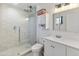 Bright bathroom featuring a glass shower with hexagon tiles, a modern vanity, and sleek fixtures at 718 W Vine Ave, Mesa, AZ 85210