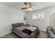 Bedroom features a ceiling fan, natural light and cozy bedding at 718 W Vine Ave, Mesa, AZ 85210