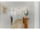 Bright entryway featuring wood floors, neutral paint, console table and artwork at 718 W Vine Ave, Mesa, AZ 85210