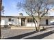 Charming one-story home featuring neutral paint, desert landscaping, and an inviting front porch at 718 W Vine Ave, Mesa, AZ 85210