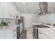 Modern kitchen featuring white cabinets, stainless steel appliances, and a spacious center island at 718 W Vine Ave, Mesa, AZ 85210