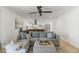 Open living room with a gray sofa, wood floors, and an open view into the kitchen at 718 W Vine Ave, Mesa, AZ 85210