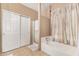 Bathroom featuring a shower and a tub with a shower curtain and a double door closet at 7214 W Crest Ln, Glendale, AZ 85310