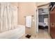 Ensuite bathroom featuring a bathtub, a towel rack and an access to the main bedroom at 7214 W Crest Ln, Glendale, AZ 85310