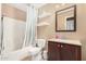 Bathroom featuring a vanity, a mirror, shelves, and a shower with blue accents at 7214 W Crest Ln, Glendale, AZ 85310