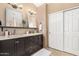 Bathroom featuring a vanity with granite countertops, dual mirrors, and great lighting at 7214 W Crest Ln, Glendale, AZ 85310