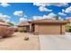 Charming single-story home featuring a desert landscape and a two-car garage at 7214 W Crest Ln, Glendale, AZ 85310