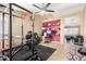 A large home gym with weights, machines, and a workout area at 7214 W Crest Ln, Glendale, AZ 85310