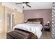 Comfortable main bedroom featuring a ceiling fan, sliding glass door, and neutral colored walls at 7214 W Crest Ln, Glendale, AZ 85310