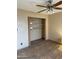 Bedroom with laminate floors, a ceiling fan, and a closet with a closet organization system at 723 E Garnet Ave, Mesa, AZ 85204