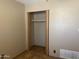 Bedroom closet featuring sliding doors, laminate wood floor, and a shelf for organization at 723 E Garnet Ave, Mesa, AZ 85204