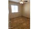 Bedroom with laminate wood floor, light tan walls, and a window providing natural light at 723 E Garnet Ave, Mesa, AZ 85204