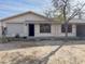 Modest single-story home with low landscaping, an open front door and an inviting facade at 723 E Garnet Ave, Mesa, AZ 85204