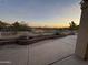 Backyard featuring a patio area with beautiful desert scenery, a brick retaining wall, and sunset views at 8199 E Sweet Acacia Dr, Gold Canyon, AZ 85118