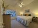 Vaulted bedroom with ceiling fan and a serene window view provides a calming space at 8199 E Sweet Acacia Dr, Gold Canyon, AZ 85118