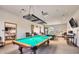 Bright game room features billiard tables under pendant lights, providing a relaxing and entertaining space at 8199 E Sweet Acacia Dr, Gold Canyon, AZ 85118