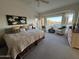 Inviting main bedroom with plush carpet, seating, and scenic views through large windows at 8199 E Sweet Acacia Dr, Gold Canyon, AZ 85118