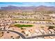 Expansive aerial view of a desert community with mountain backdrop and golf course at 8212 E Masters Rd, Gold Canyon, AZ 85118