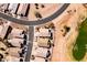 Aerial view of desert homes bordering manicured golf course with lush, green fairway at 8212 E Masters Rd, Gold Canyon, AZ 85118