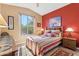 Inviting bedroom features a colorful area rug, a bedside table with a lamp, and a window view of the outdoors at 8212 E Masters Rd, Gold Canyon, AZ 85118