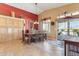 Elegant dining room with a rustic table, high ceilings, and a sliding door for outdoor access at 8212 E Masters Rd, Gold Canyon, AZ 85118