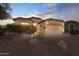 Well-lit home exterior showcasing desert landscaping and a two-car garage at 8212 E Masters Rd, Gold Canyon, AZ 85118