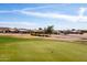 View of the immaculate golf course with manicured green and surrounding desert landscape at 8212 E Masters Rd, Gold Canyon, AZ 85118