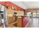 Stylish kitchen with stainless steel appliances, a vibrant red accent wall, and ample cabinet space for storage at 8212 E Masters Rd, Gold Canyon, AZ 85118