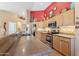 Spacious kitchen boasts a large countertop, stainless steel appliances, and a stylish red accent wall at 8212 E Masters Rd, Gold Canyon, AZ 85118