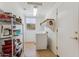 Functional laundry room featuring washer, dryer, shelving, and storage, with a tiled floor at 8212 E Masters Rd, Gold Canyon, AZ 85118