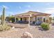 Desert home featuring covered patio and manicured, drought-tolerant landscaping at 8212 E Masters Rd, Gold Canyon, AZ 85118