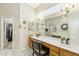 Bright bathroom featuring double sinks and a linen closet at 906 E Beautiful Ln, Phoenix, AZ 85042