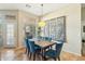 Bright dining room featuring a table with blue chairs, decorative wall art, and tile flooring at 906 E Beautiful Ln, Phoenix, AZ 85042