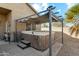 Relax in this backyard hot tub under the shade of a stylish pergola with privacy included at 906 E Beautiful Ln, Phoenix, AZ 85042