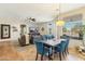 Open-concept living room with a dining area featuring stylish blue chairs and a large window for natural light at 906 E Beautiful Ln, Phoenix, AZ 85042