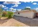 The backyard features a stone ground and the back of the home with the roof visible at 917 N Nina Dr, Mesa, AZ 85201