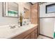 This bathroom features a double sink vanity with wood cabinetry and a decorative border at 917 N Nina Dr, Mesa, AZ 85201