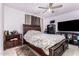 This bedroom features a ceiling fan, hardwood furniture, and a patterned rug at 917 N Nina Dr, Mesa, AZ 85201