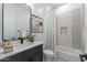 Modern bathroom featuring a stylish vanity with a vessel sink, a decorative mirror, and tiled shower at 9230 E Cloudview Ave, Gold Canyon, AZ 85118