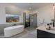 Relaxing bathroom featuring a soaking tub, glass-enclosed shower, stylish fixtures, and desert views at 9230 E Cloudview Ave, Gold Canyon, AZ 85118